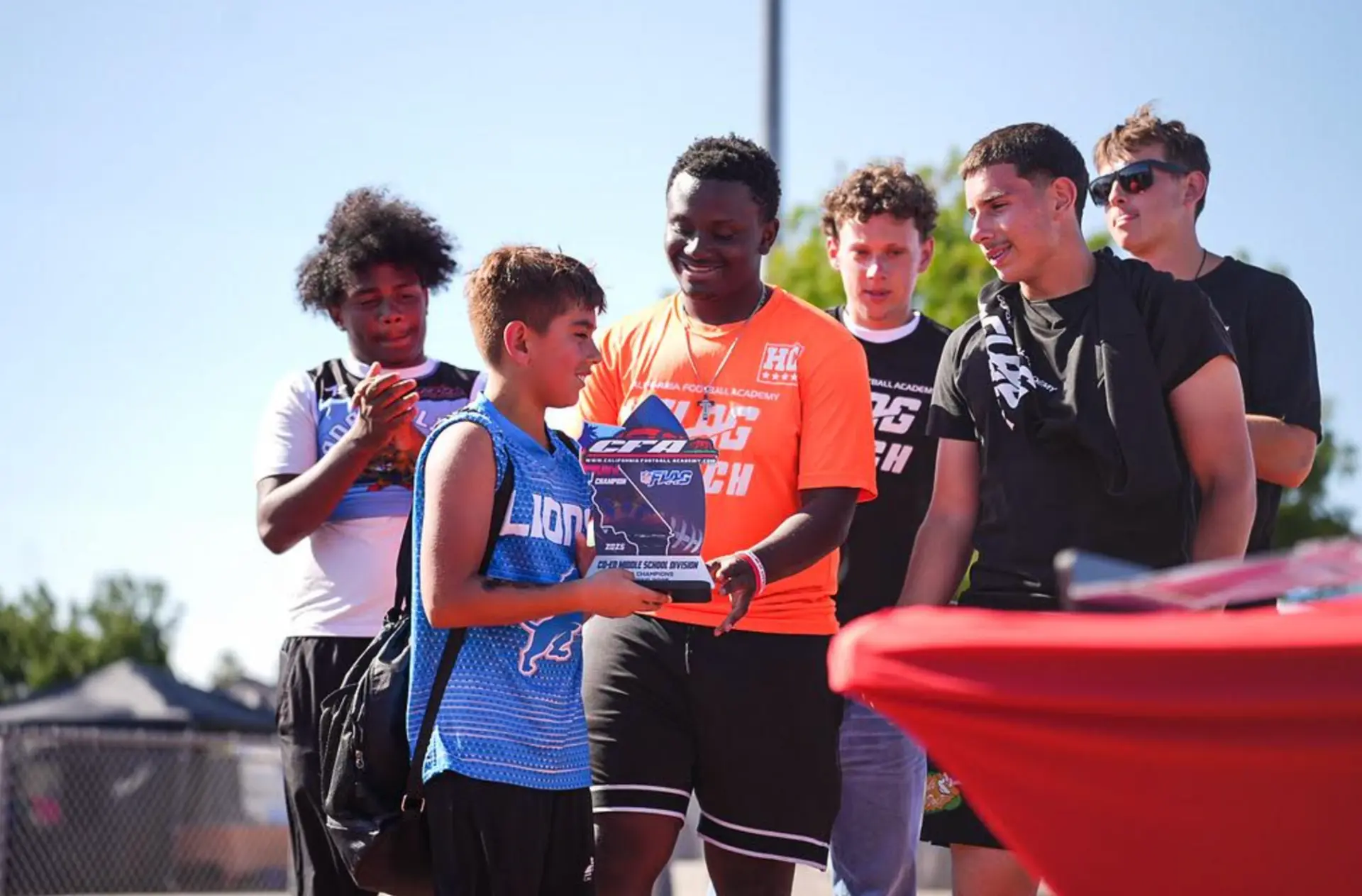 CFA athletes celebrating with a trophy